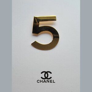 CHANEL classic gold number 5 brooch pin. 2.25" h x 1.5" w
